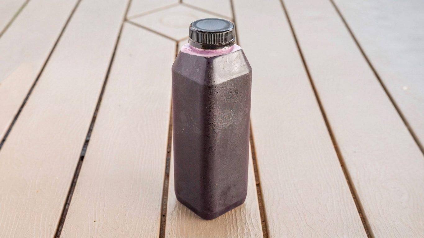 Bottle of dark red hibiscus drink