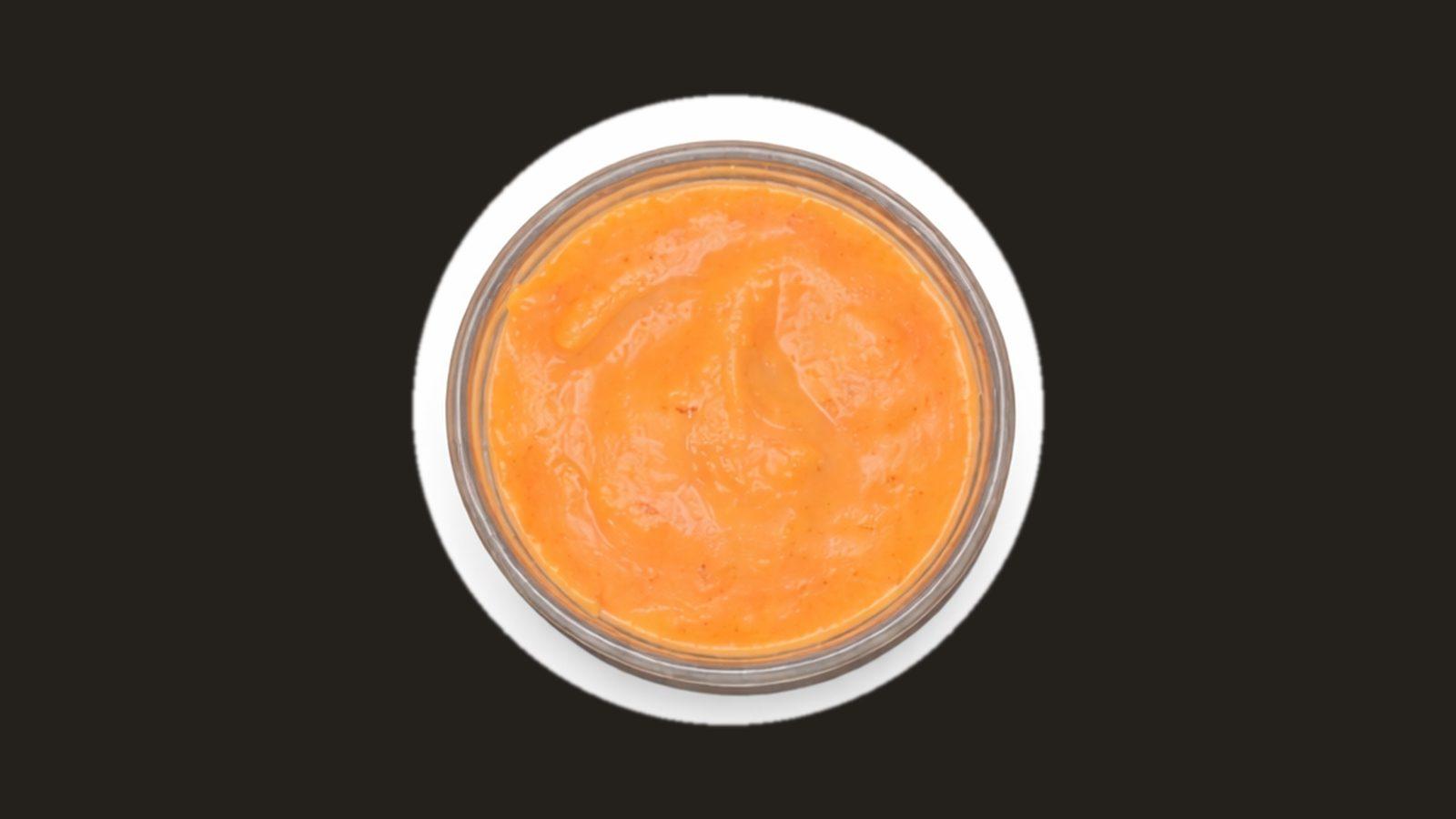 Cup of orange Nomad sauce