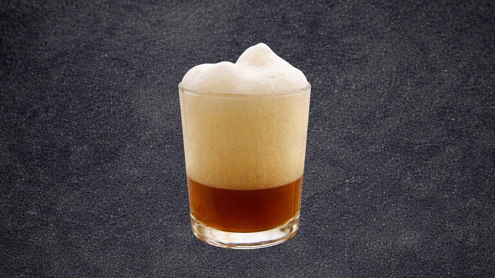 Glass of Saharan black tea with a thick foam on top