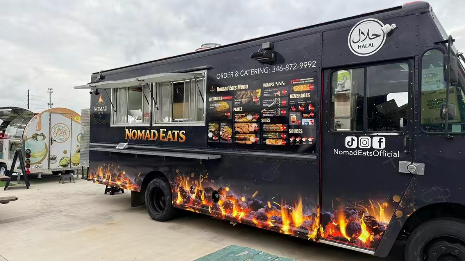 The Nomad Eats truck from the cab side, with the Halal badge and the phone number for orders and catering
